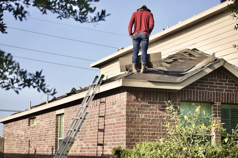 Professional roofer working on a residential roof in Kerrsville